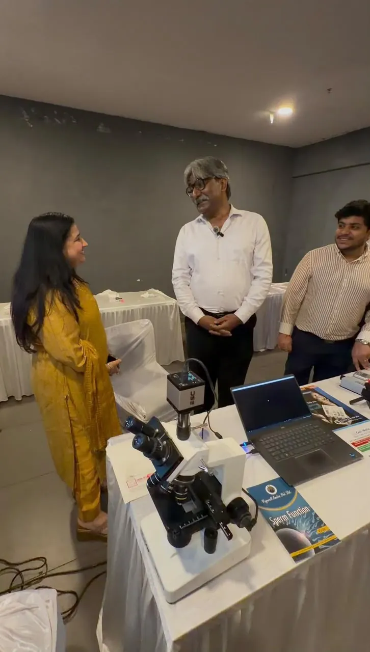 A participant at the microscope during the andrology demonstration at FOGSI Jaipur