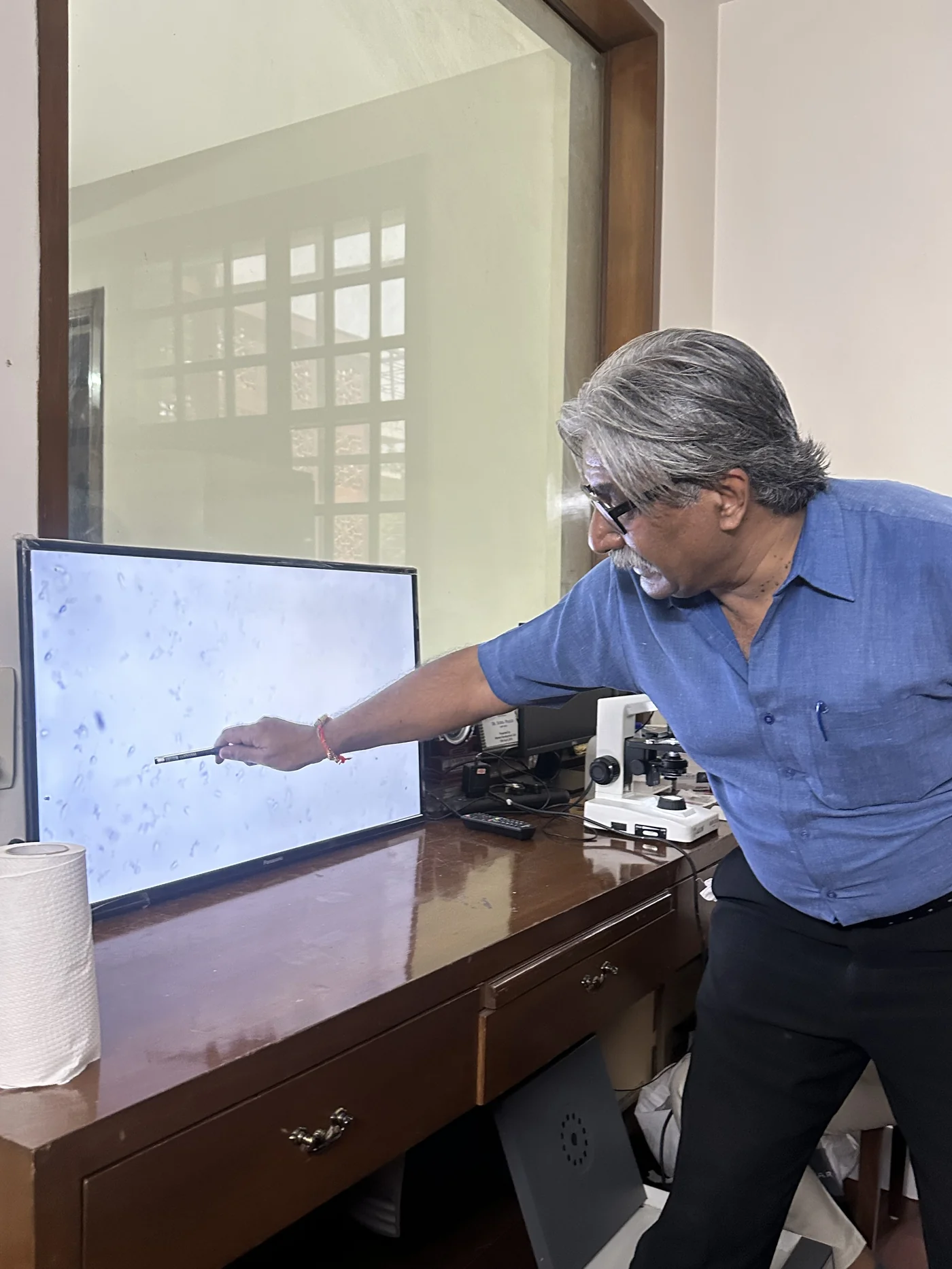 Sperm morphology and motility being taught at the microscope during a hands-on session for gynaecologists