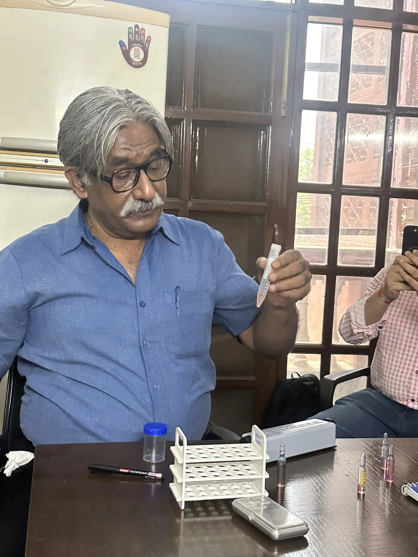 Rajnish Sehgal demonstrating semen sample handling during small-group andrology training for doctors